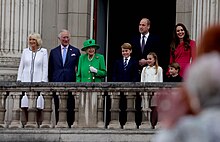 Catherine, William and their children stand with Queen Elizabeth II and Prince Charles on the balcony of Buckingham Palace