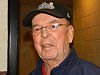Bob Cole looking at the camera while wearing a black baseball cap on his head and spectacles over his eyes