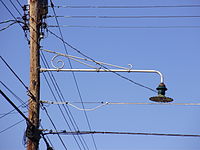 Street light from the 1950s attached to a utility pole in New Jersey