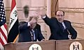George W. Bush (l) and Nouri al-Maliki (r) defend themselves against a thrown shoe