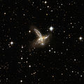 ESO 593-8 is an impressive pair of interacting galaxies with a feather-like galaxy crossing a companion galaxy.