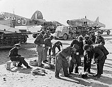 Personnel of No. 53 Repair and Salvage Unit in the Western Desert while transporting salvaged Hawker Hurricane fuselages to Helwan, Egypt during the Second World War.