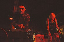 A photo of Ryan George and Sara Taylor performing live as Youth Code in 2014.
