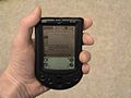 A bit of my hand holding a Palm m100. Used on the Palm (PDA) page.