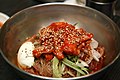 Hoe naengmyeon, hot and spicy cold buckwheat noodles with hoe (raw fish).