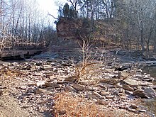 The remains of the 18th-19th century cut across the peninsula of the Jug, as viewed in 2006. The creek is partially prevented from flowing here by the dam effect of the low water bridge visible at left (see photograph below); the creek is slightly visible at right, having emerged from a 3.3 mile (5.3 km) meander.