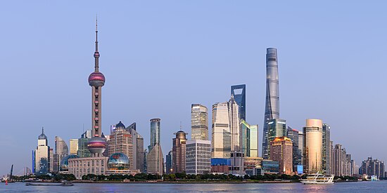 Skyline of the Pudong district of Shanghai, seen from the water at dusk.