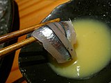 Kibinago sashimi with chopsticks