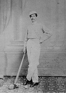 A portrait of William Shuttleworth leaning on his bat
