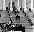The remains of Dwight D. Eisenhower being carried down the center steps of the east front of the United States Capitol Building by honor guards, 1969.