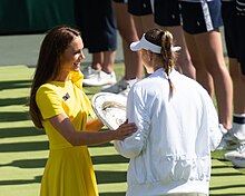 Catherine presenting a trophy to a female tennis player at Wimbledon