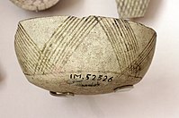 Fragment of pottery with incised and painted decor. From Tell Hassuna, 6500 - 6000 BCE.