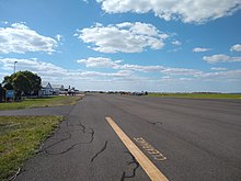 A view of the Dalby Airport apron from the fuel pumps, looking West. Runway 13/31 runs parallel to the apron, while 04/22 is perpendicular and is at the western end of the apron.