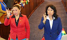 Senators Patricia Gómez and Mirtha Arce make a sign of the cross with their right hands as they are sworn into the Senate Ethics Commission.