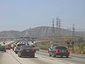 The HVDC power line in Los Angeles (shorter tower carrying two wires on the right). The power line crosses Interstate 5 near the interchange with Interstate 210 in Sylmar.