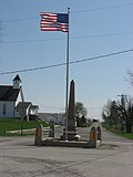 World War I veterans memorial in Pickrelltown (2010 photo). The 8 ft (2.4 m) high granite monument was erected in 1921, and has twice been rebuilt after vehicles crashed into it.[6][7]