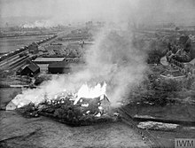 'Crocodile' flame throwing tanks were used against German positions to the East of 's-Hertogenbosch. On the left of the picture is a German Red Cross train intact.