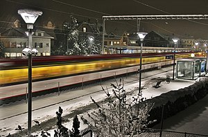 Wintry evening as a motion-blurred train passes platforms