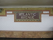Tilework in original station, which includes a mosaic tile sign saying "Atlantic Avenue"