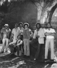 1976 B/W image of original members standing