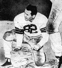 James on the ground holding a kick during the 1950 season