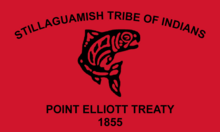 The flag of the Stillaguamish Tribe of Indians, a red banner with a salmon in the formline style. The words "Stillaguamish Tribe of Indians" is written above and the words "Point Elliot Treaty 1855" written below