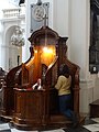 A confessional in the Roman Catholic Holy Cross Church in time of a confession, Warsaw, Poland