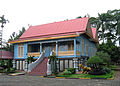 Rumah Lipat Kajang style, a Sumatran Riau Malay traditional house with tiled stairs at Taman Mini Indonesia theme park.