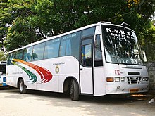 White bus with a tricolor swoosh