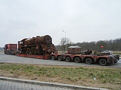 Steam locomotive on lowboy