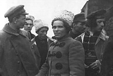 Nestor Makhno and Fedir Shchus standing together with other Makhnovists in front of a train