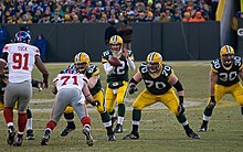 Packers and Giants players lining up during the snap of the football to quarterback Aaron Rodgers