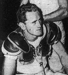 A black and white photo of Baldwin wearing his football pads