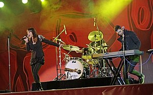 Rogue Traders performing live at FIFA Fan Fest, Sydney, June 2010. Mindi Jackson at left, James Ash at right, Peter Marin obscured behind drum kit.