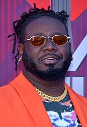 a photo of T-Pain posing on the red carpet.