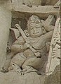 India, 7th-8th century C.E. Figure holding an Alapini vina at Kailasanathar Temple