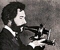 Image 44Actor portraying Alexander Graham Bell in a 1932 silent film. Shows Bell's second telephone transmitter (microphone), invented 1876 and first displayed at the Centennial Exposition, Philadelphia. (from History of the telephone)