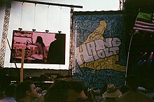 The crowd at a concert with a large banner reading "HANG OUT"