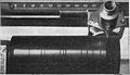 Cylinder on Dictaphone dictation machine (c. 1922). The recording head moved left to right. The black lines are shiny gaps between tracks. Each cylinder could record 1,200 to 1,500 words. They could be reused 100 to 120 times by putting them in a machine that erased them by shaving off the surface.