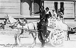This is a photograph of students on horse cart taking part in the annual Prosh event, poking fun at Nobel Prize laureates Bragg and Bragg. A poster reads "Do not Bragg about radium".