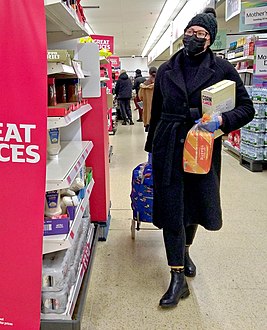 Shopping in gloves and a face mask, London, 15 March.