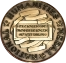 Gold medallion emblazoned with the motto "Expanding Our Understanding of the World"