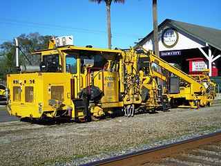 Ballast tamping machine as used in railroad track maintenance in Florida
