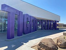 A photograph of a building, with "Tiger Pride" in purple.