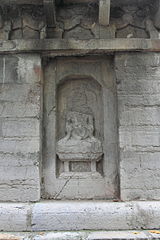 Damaged artistry in a niche on the first storey