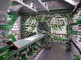 Inside view of a small house made of thousands of glass bottles