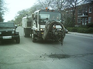 Spray-injection device for pothole repair—all-in-one repair unit in Montreal, which allows the operator to work from the comfort and safety of the cab