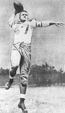Black and white photo of Rohrig in uniform about to throw a football