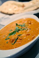 Chicken tikka masala, adapted from Indian chicken tikka and called "a true British national dish." The dish is now popular staple in Indian restaurants worldwide.[41]