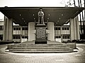Statue of Mr. Lee Kong Chian, a major donor, after whom the Kong Chian Administration Centre in the background is named